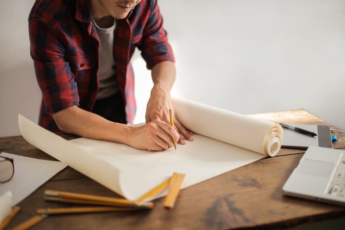 Architect's desk with workstation and drawings — architecture firm IT